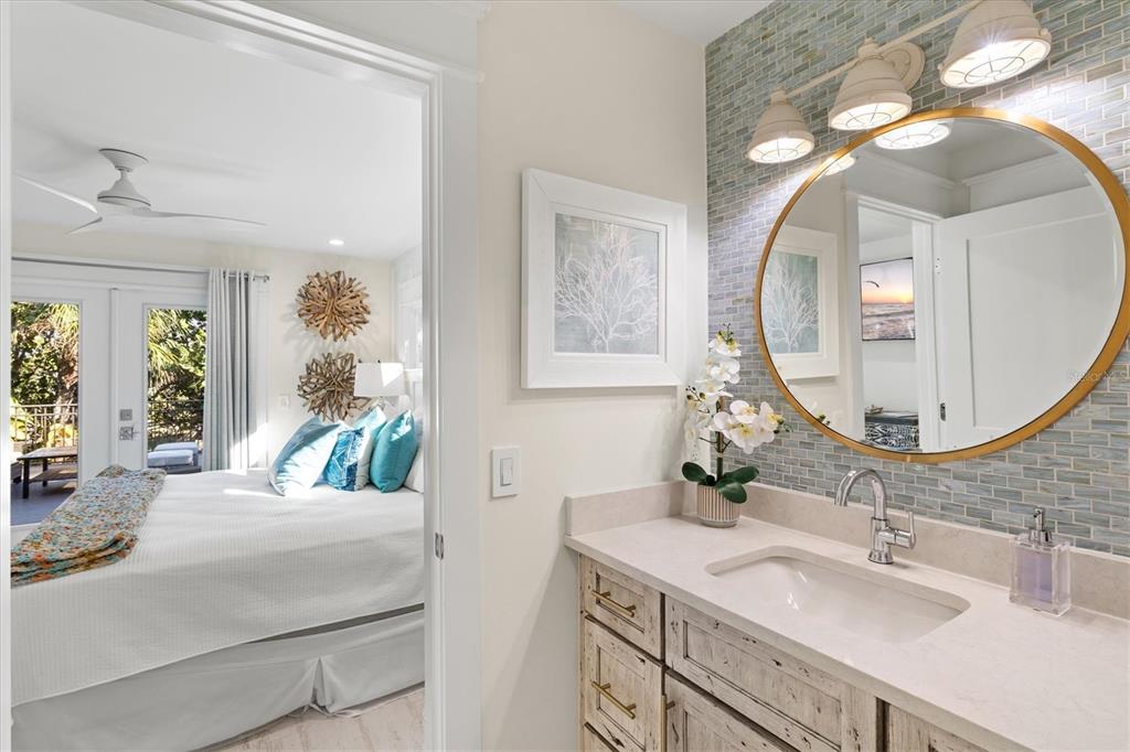 506 58th Street Holmes Beach, FL 34217 - Photo 68 of 95 a en suite bathroom with a double vanity sink and a mirror