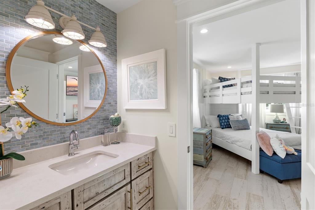 506 58th Street Holmes Beach, FL 34217 - Photo 73 of 95 a en suite bathroom with a double vanity sink and a mirror