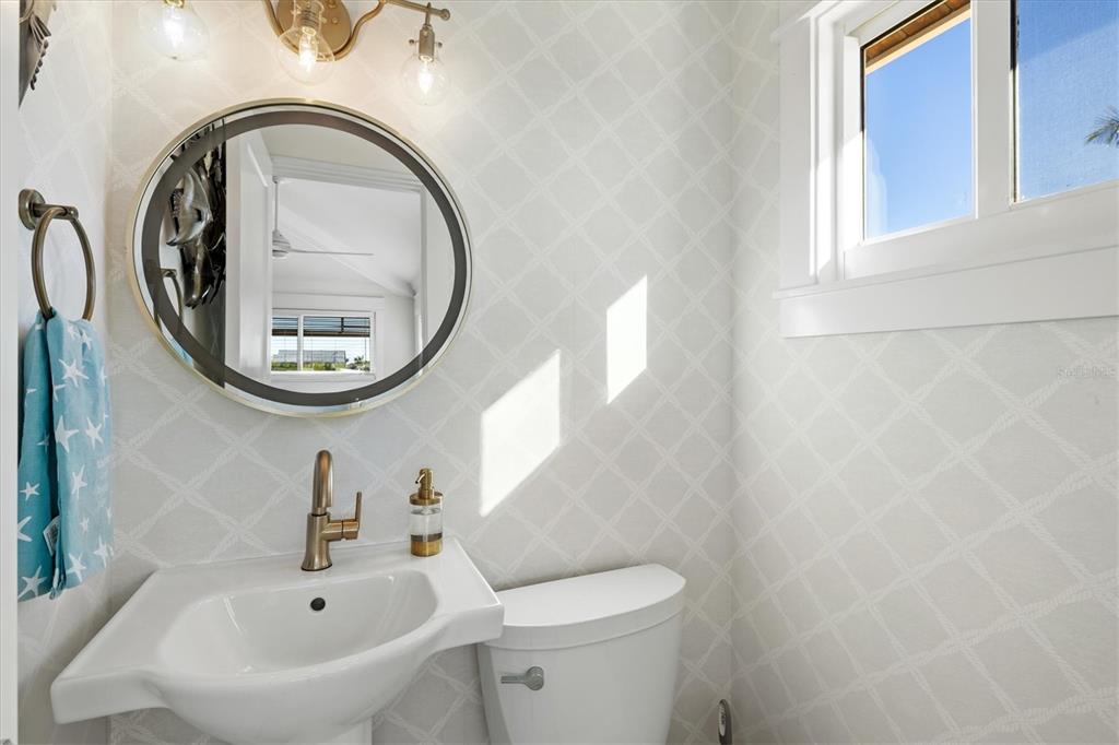 506 58th Street Holmes Beach, FL 34217 - Photo 79 of 95 a bathroom with a sink and a mirror