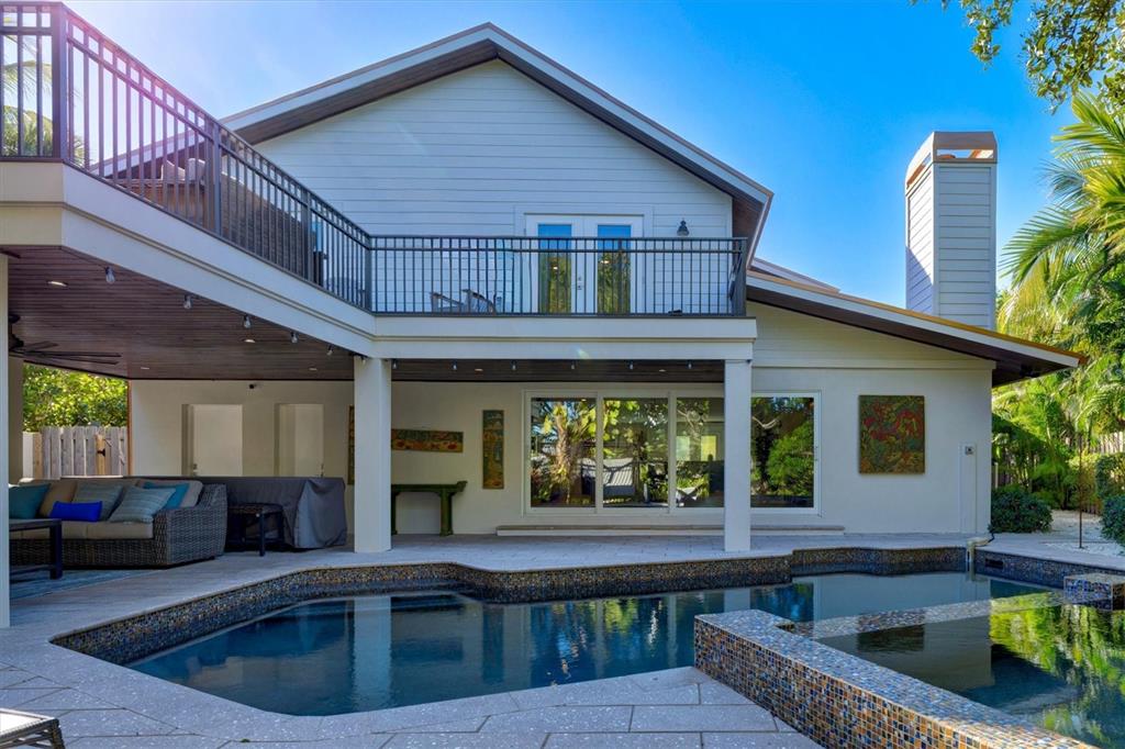506 58th Street Holmes Beach, FL 34217 - Photo 82 of 95 a view of a house with a swimming pool
