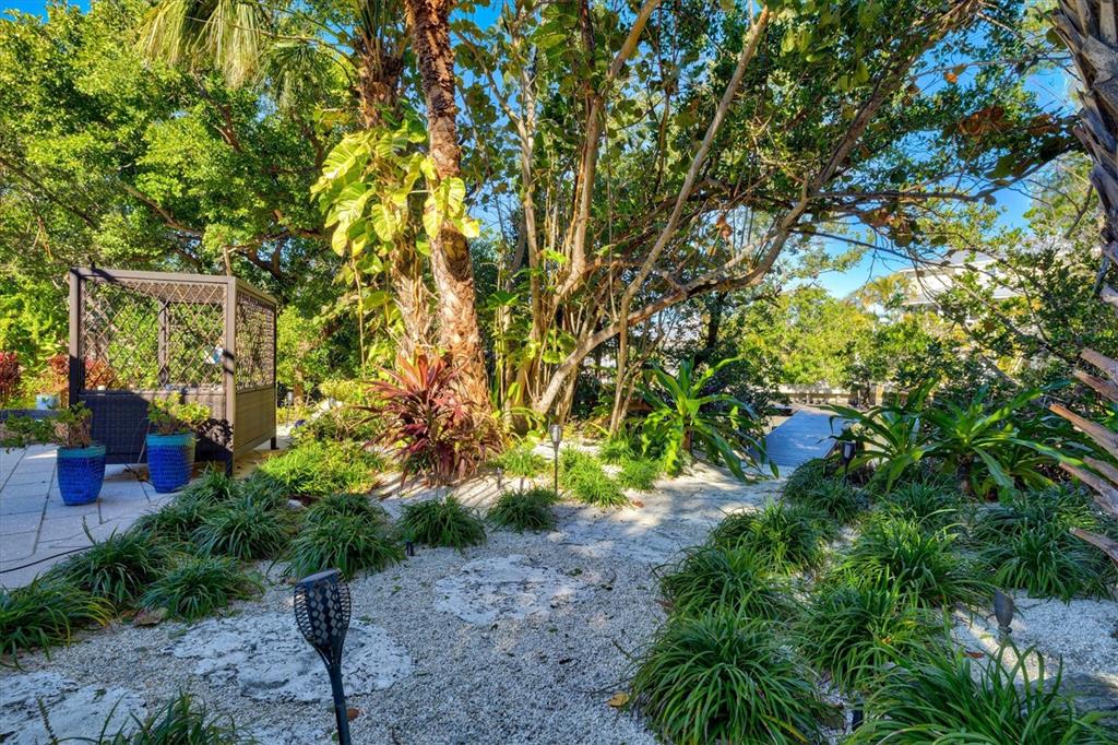 506 58th Street Holmes Beach, FL 34217 - Photo 89 of 96 a backyard of a house with lots of green space