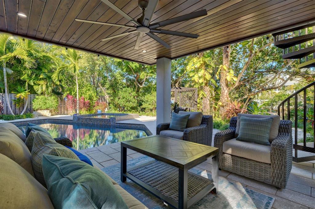 506 58th Street Holmes Beach, FL 34217 - Photo 91 of 95 a outdoor living space with furniture and garden view