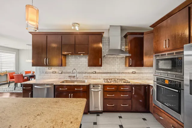a kitchen with stainless steel appliances a stove sink and cabinets