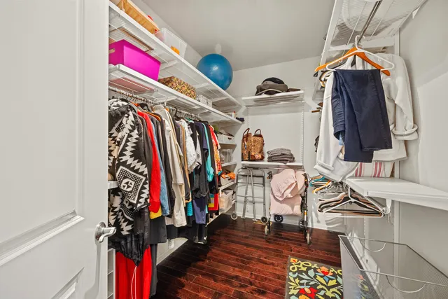 a view of walk in closet with clothes