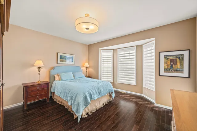 a bedroom with a bed and a lamp on table