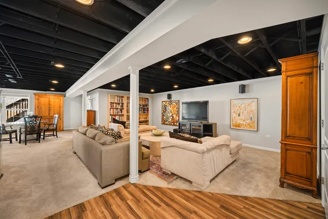 a living room with furniture a flat screen tv and next to a window