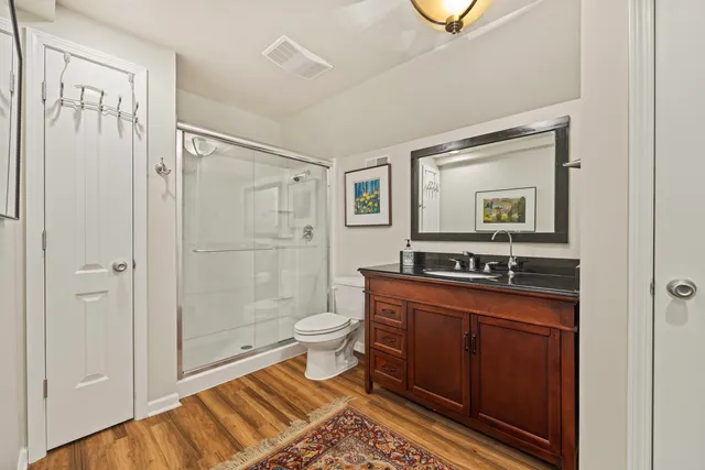 a bathroom with a toilet a sink and mirror