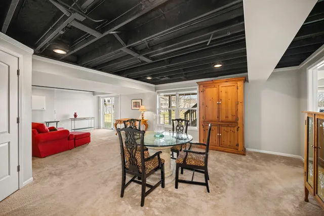 a dining room with furniture and a window