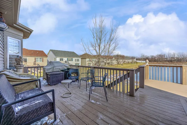 a view of a balcony with wooden floor and outdoor seating