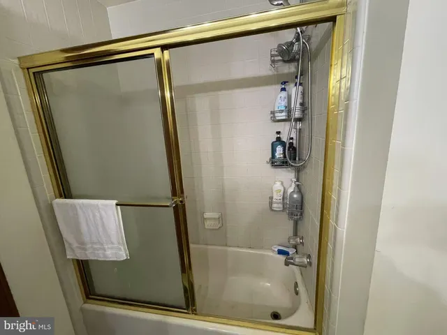 a bathroom with a glass shower door