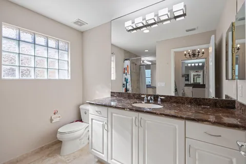 a bedroom with a bed and a chandelier fan