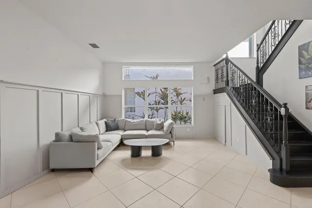 a living room with furniture and a potted plant