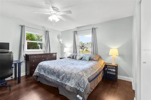 a bedroom with a bed a window and dresser