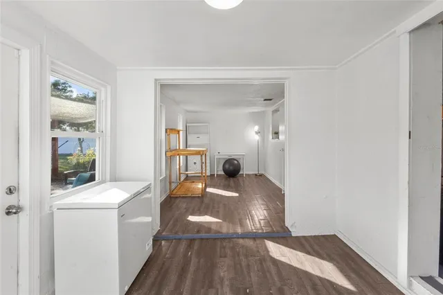 a bedroom with a bed and glass door
