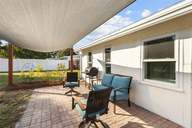 a view of a patio with table and chairs and wooden floor