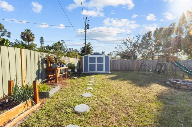 a swimming pool with outdoor seating and yard