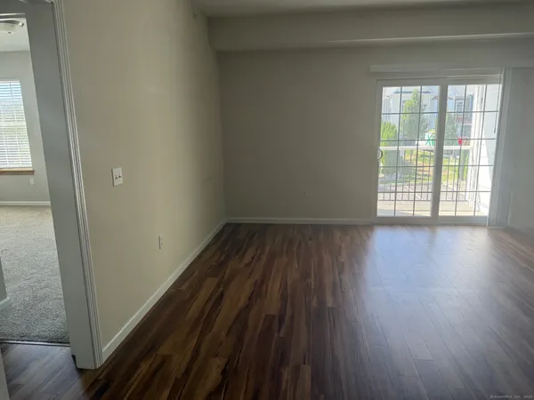 a view of a room with wooden floor and window