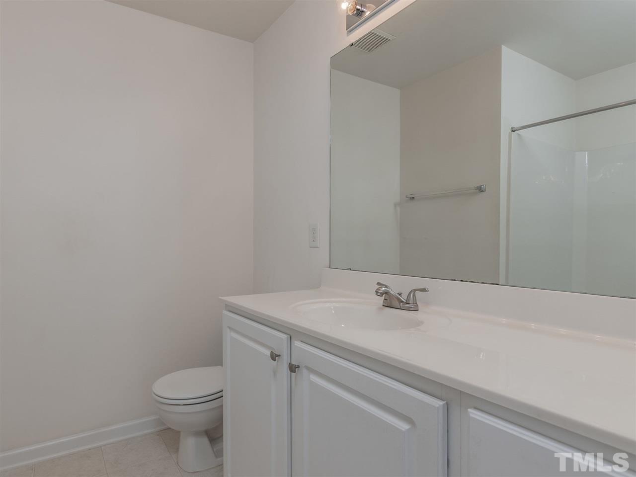 8274 City Loft Court Raleigh, NC 27613 - Photo 13 of 20 a bathroom with a sink toilet and a mirror