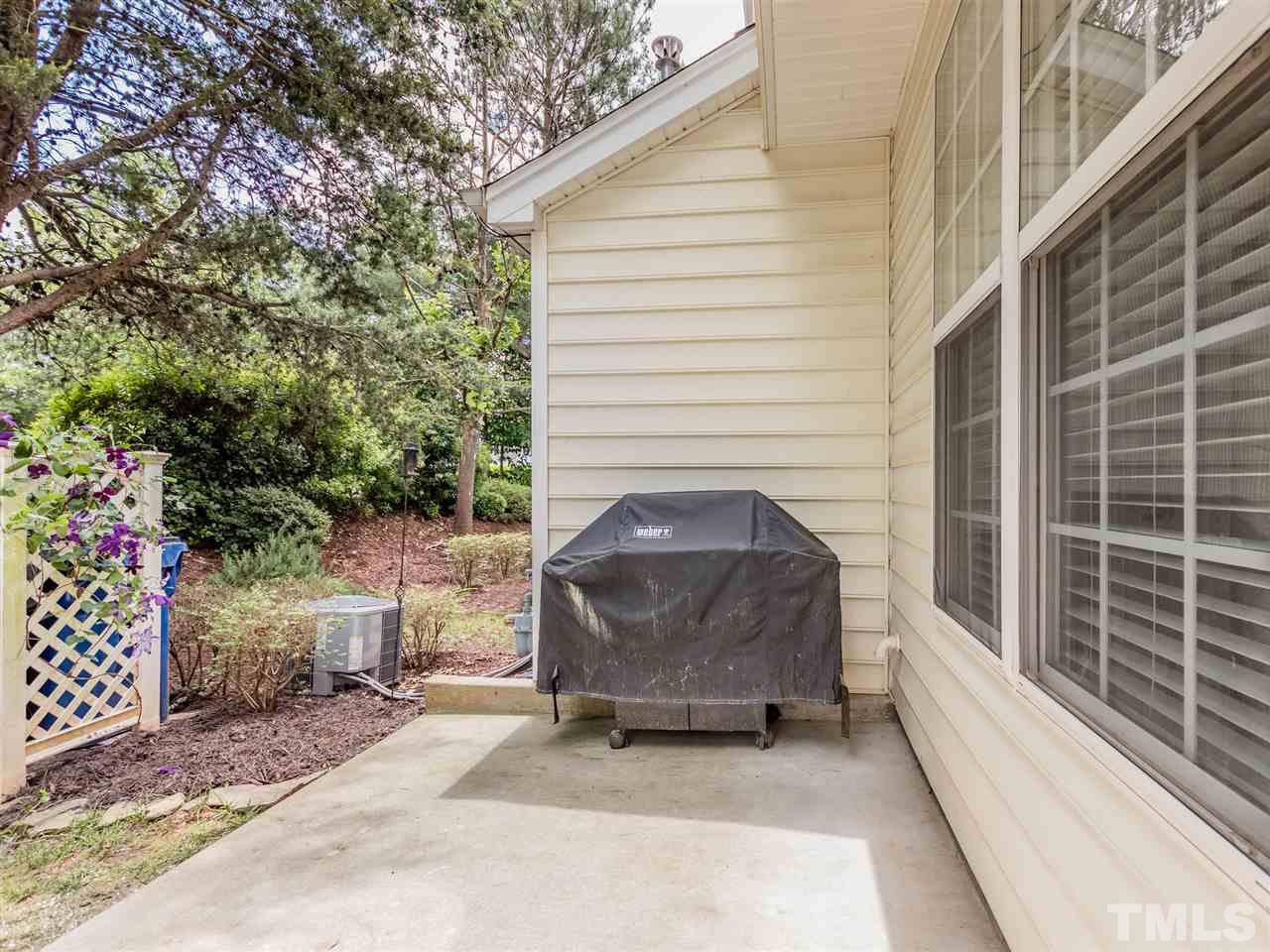 8274 City Loft Court Raleigh, NC 27613 - Photo 17 of 20 a view of a chair and fire pit in the back yard