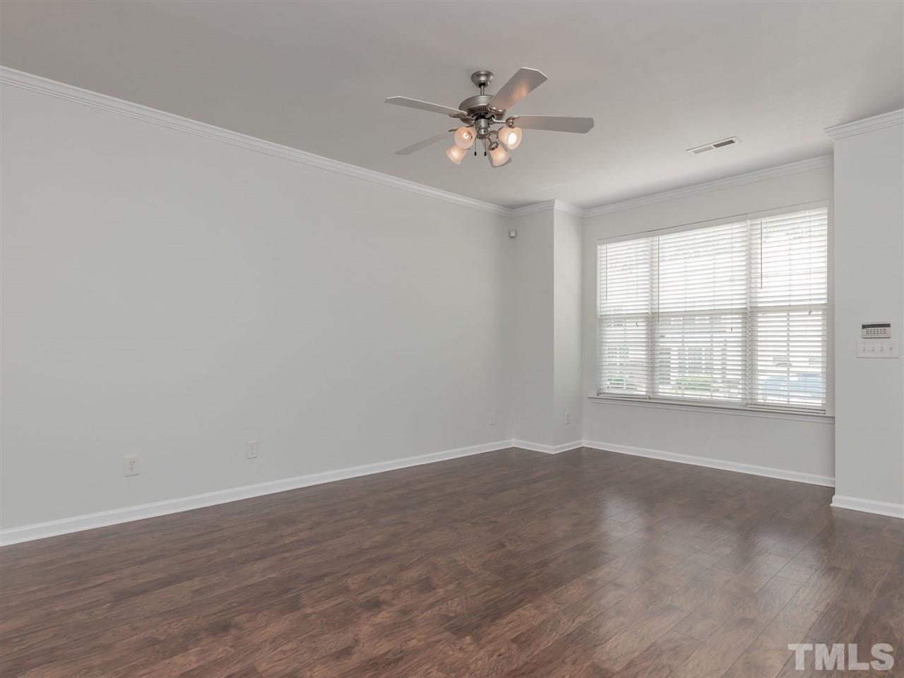 8274 City Loft Court Raleigh, NC 27613 - Photo 4 of 20 a view of an empty room with wooden floor and a window