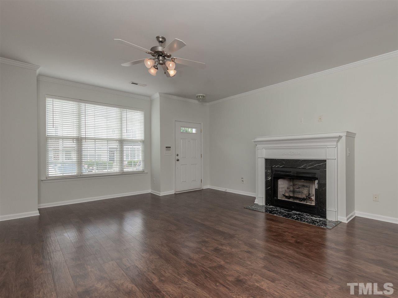 8274 City Loft Court Raleigh, NC 27613 - Photo 5 of 20 wooden floor fireplace and windows in an empty room