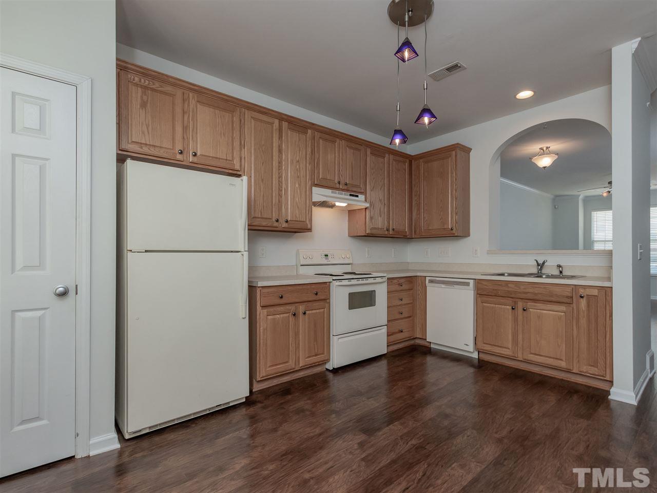 8274 City Loft Court Raleigh, NC 27613 - Photo 7 of 20 a kitchen with granite countertop a refrigerator sink and cabinets