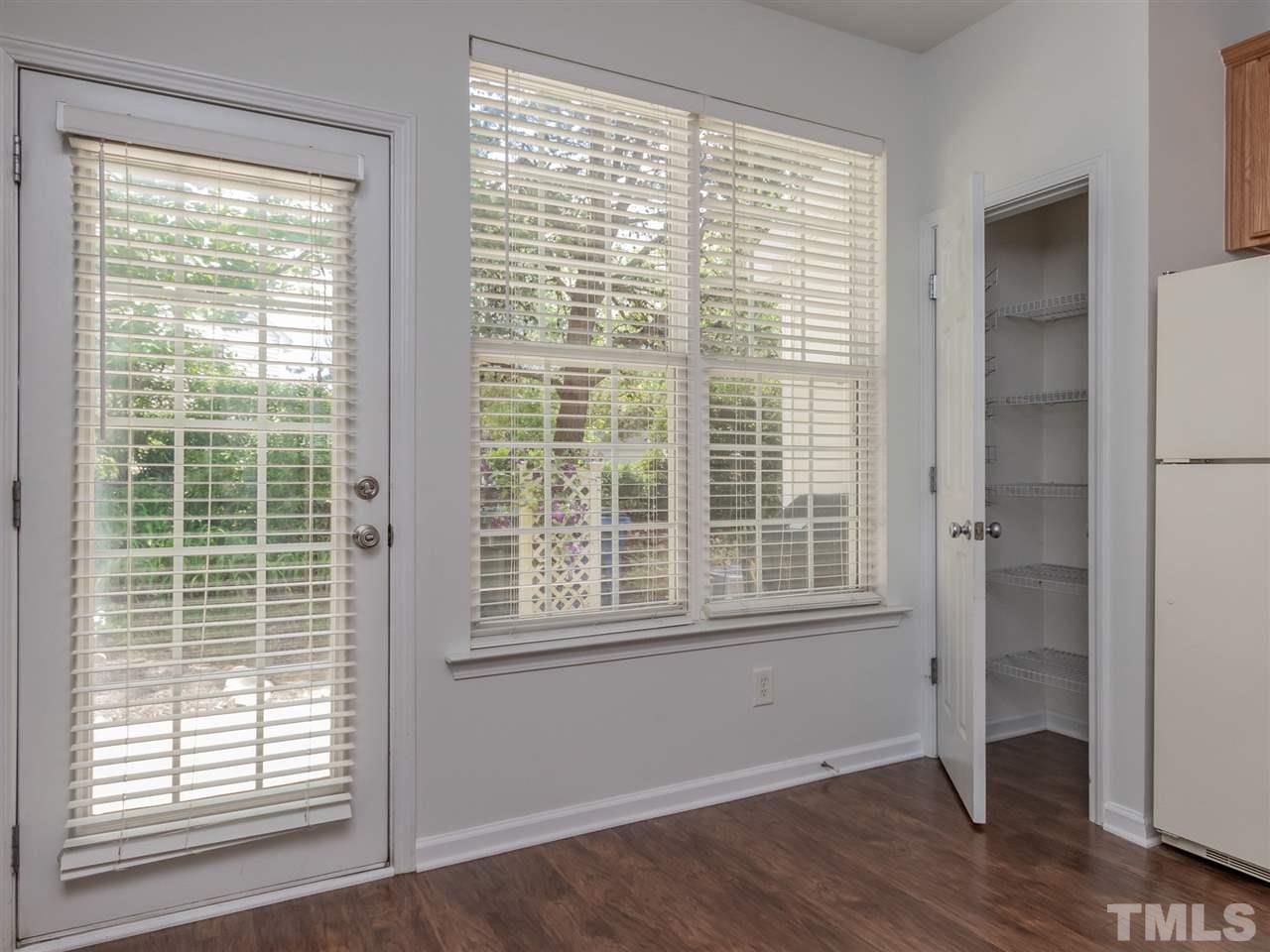 8274 City Loft Court Raleigh, NC 27613 - Photo 8 of 20 a view of an empty room with wooden floor and a window