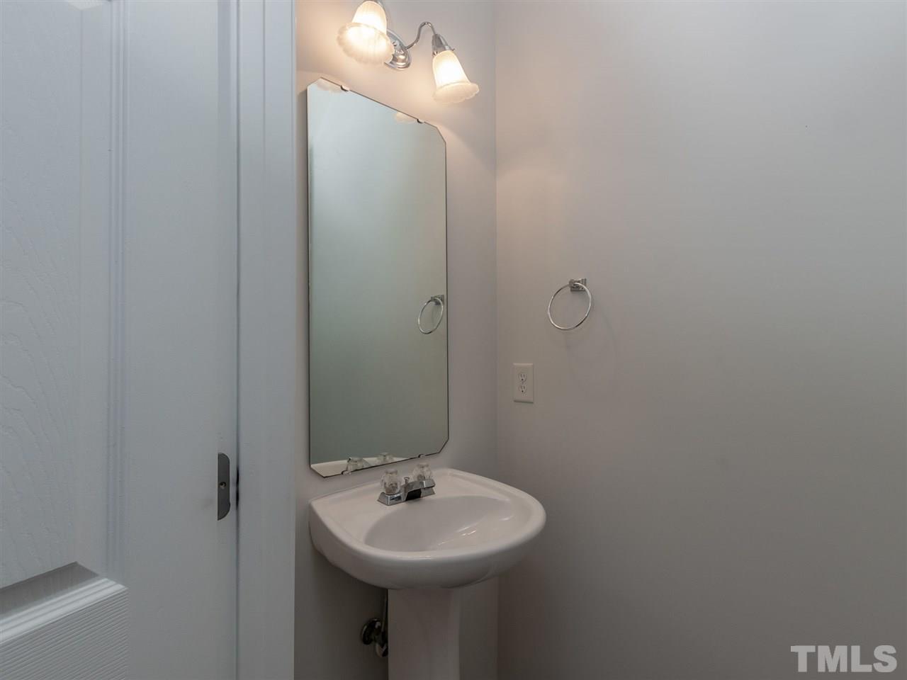 8274 City Loft Court Raleigh, NC 27613 - Photo 9 of 20 a bathroom with a sink and mirror