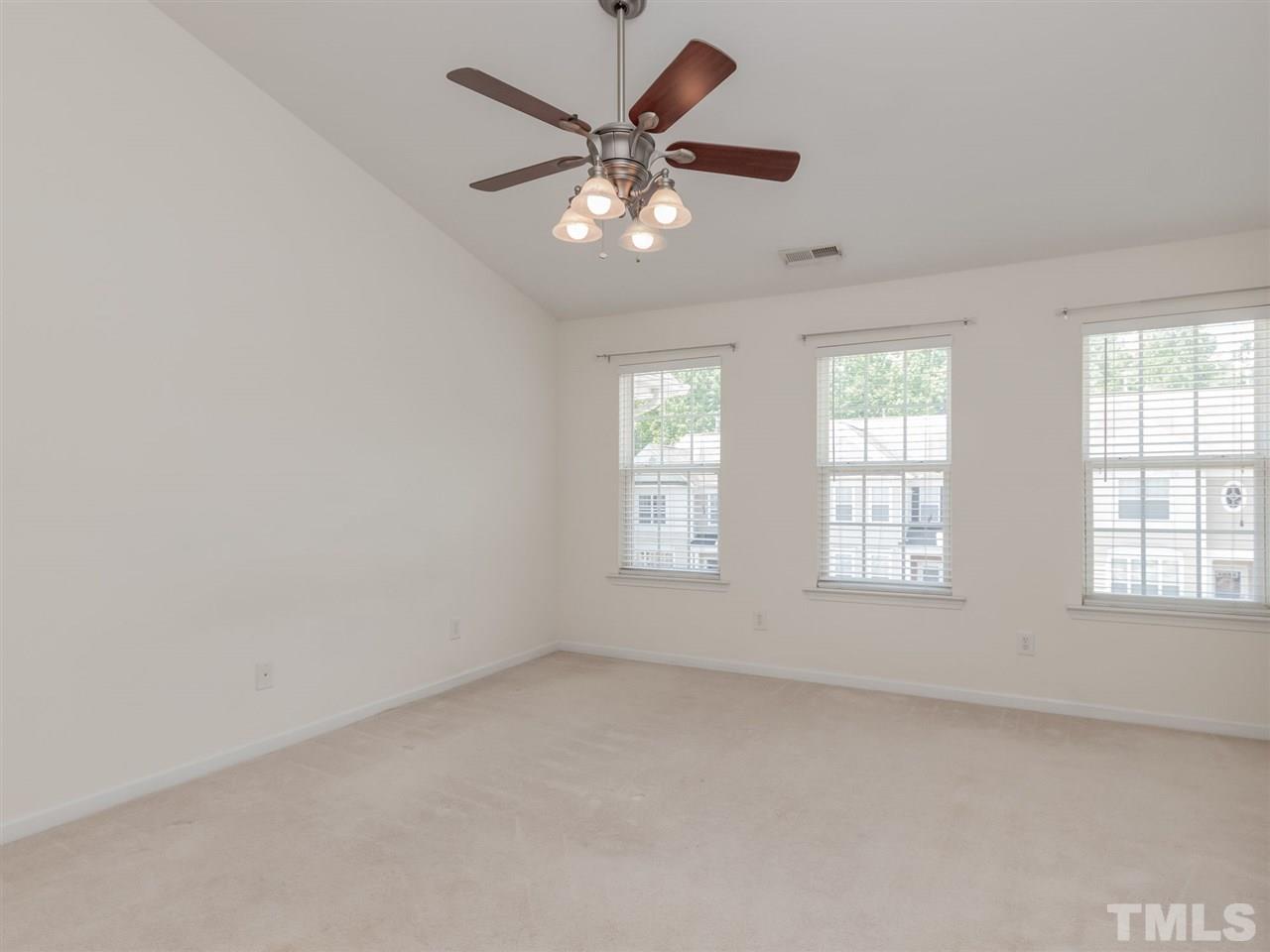 8274 City Loft Court Raleigh, NC 27613 - Photo 10 of 20 an empty room with chandelier fan and windows