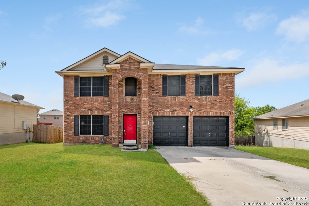 a front view of a house with a yard and garage