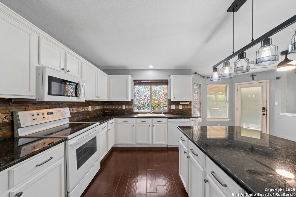 8411 Copperbluff Converse, TX 78109 - Photo 11 of 31 a kitchen with stainless steel appliances granite countertop a sink and cabinets