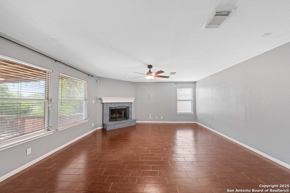 8411 Copperbluff Converse, TX 78109 - Photo 14 of 31 a view of an empty room with a window and fireplace
