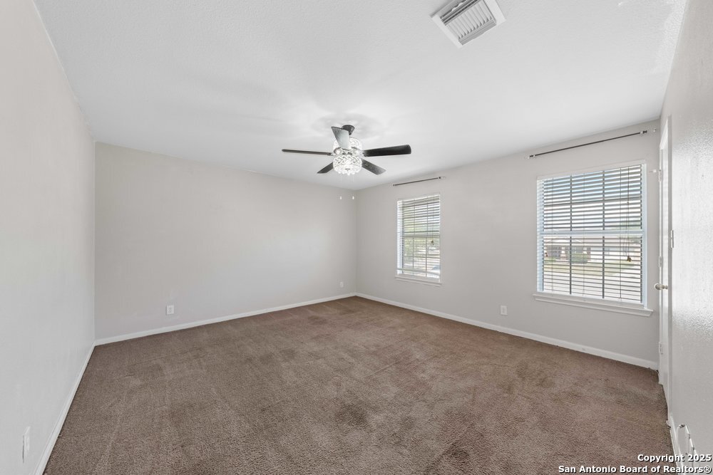 8411 Copperbluff Converse, TX 78109 - Photo 16 of 31 an empty room with windows and ceiling fan