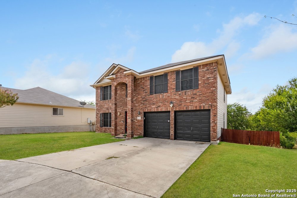 8411 Copperbluff Converse, TX 78109 - Photo 2 of 31 a front view of a house with a yard and garage