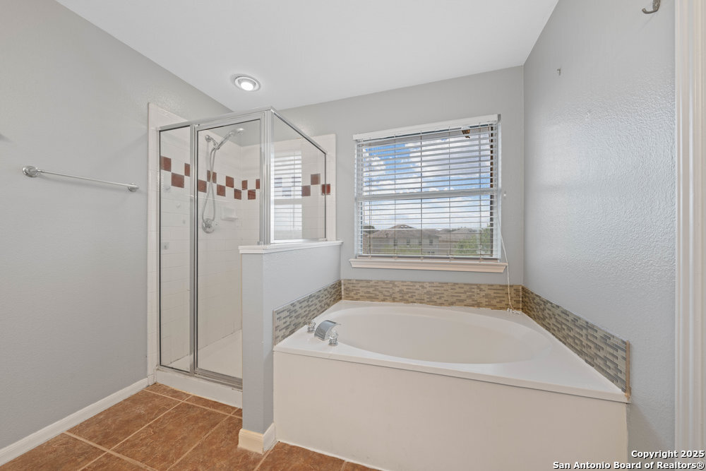 8411 Copperbluff Converse, TX 78109 - Photo 22 of 31 a bathroom with a bathtub and a shower