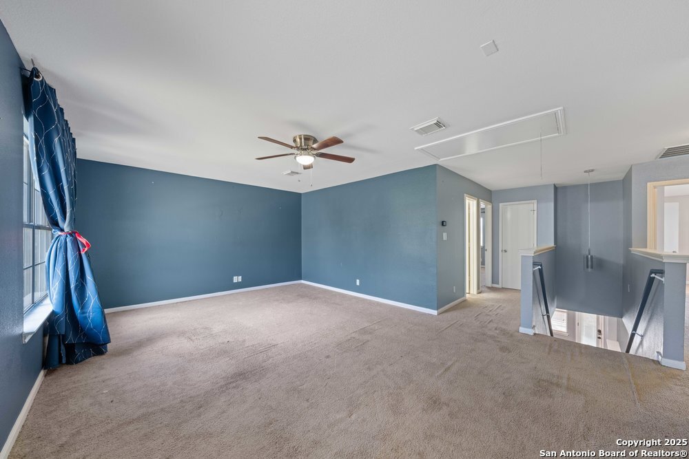 8411 Copperbluff Converse, TX 78109 - Photo 25 of 31 a view of a livingroom with furniture and a ceiling fan