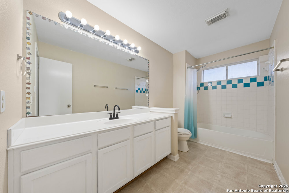 8411 Copperbluff Converse, TX 78109 - Photo 28 of 31 a bathroom with a double vanity sink mirror and toilet