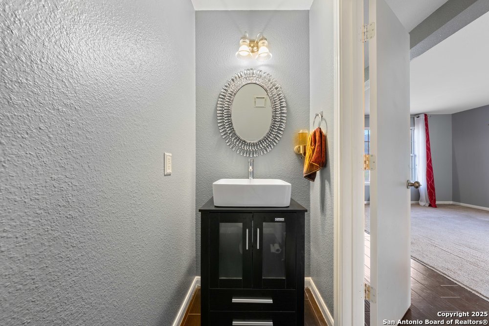 8411 Copperbluff Converse, TX 78109 - Photo 8 of 31 a bathroom with a sink and a mirror