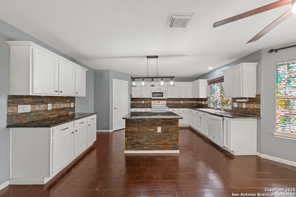 8411 Copperbluff Converse, TX 78109 - Photo 9 of 31 a large kitchen with granite countertop a stove and a sink