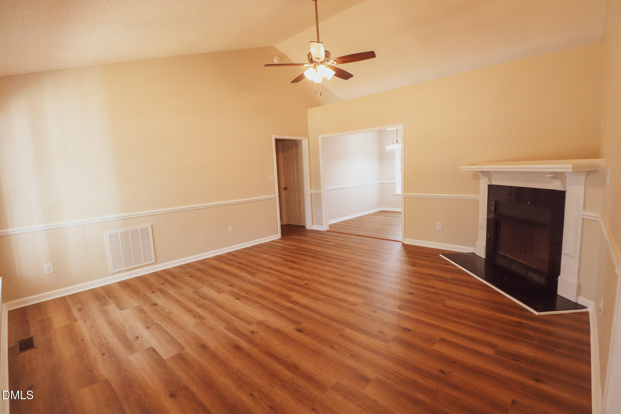 55 Edward Court Willow Spring, NC 27592 - Photo 14 of 25 an empty room with wooden floor a ceiling fan and windows