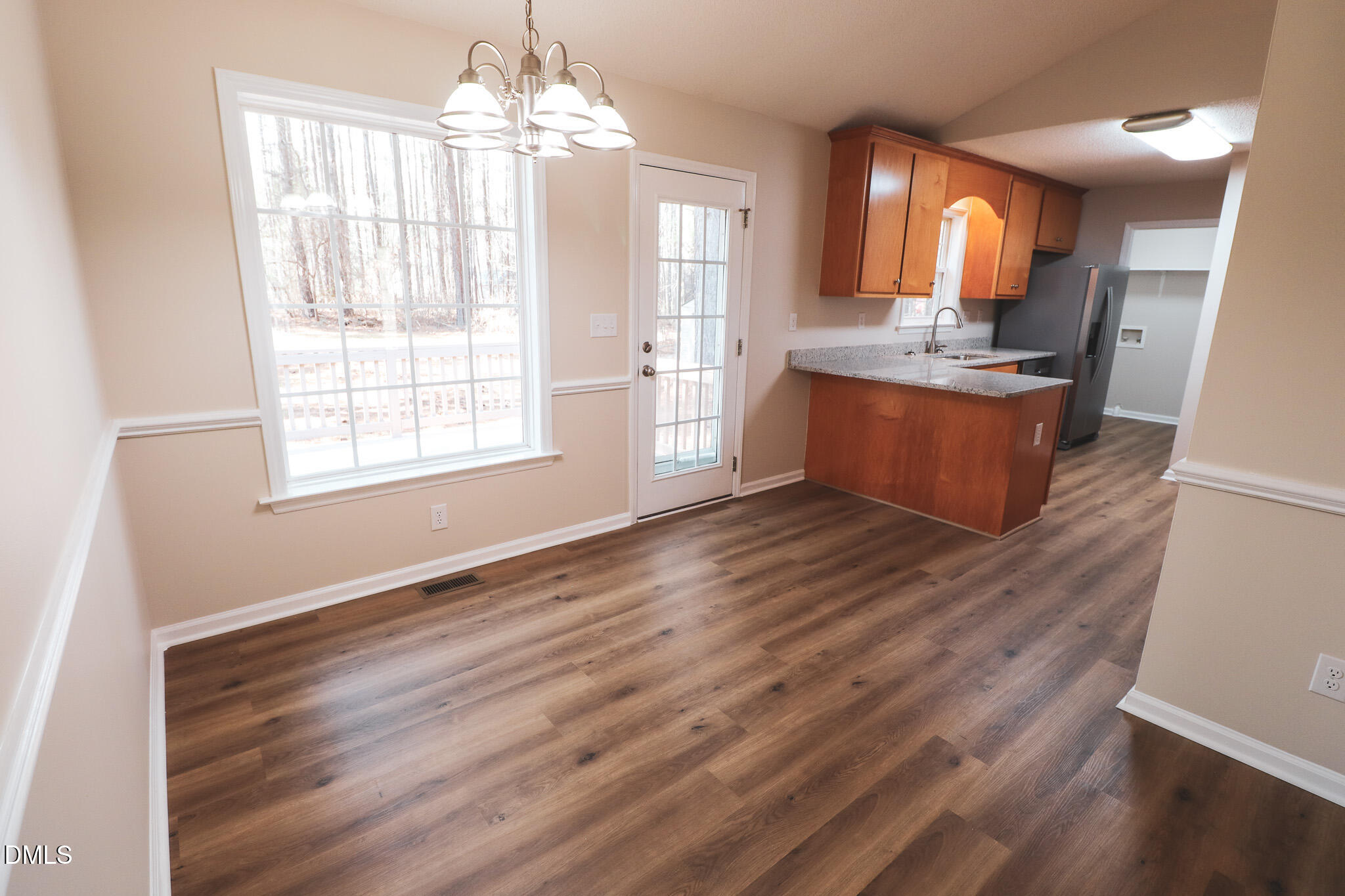 55 Edward Court Willow Spring, NC 27592 - Photo 19 of 25 a kitchen with granite countertop wooden floors and wide window
