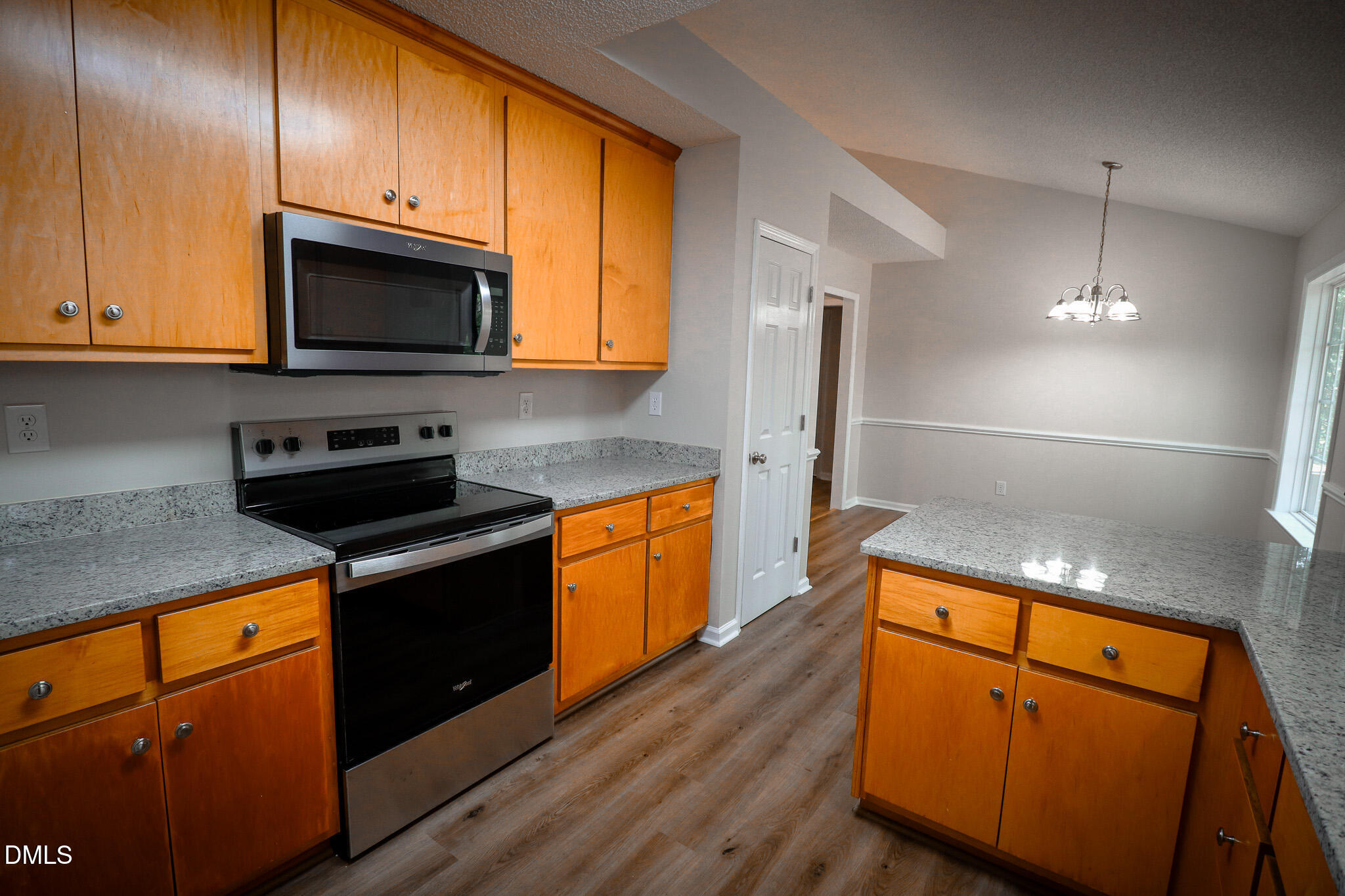 55 Edward Court Willow Spring, NC 27592 - Photo 20 of 25 a kitchen with granite countertop wooden cabinets and a stove top oven