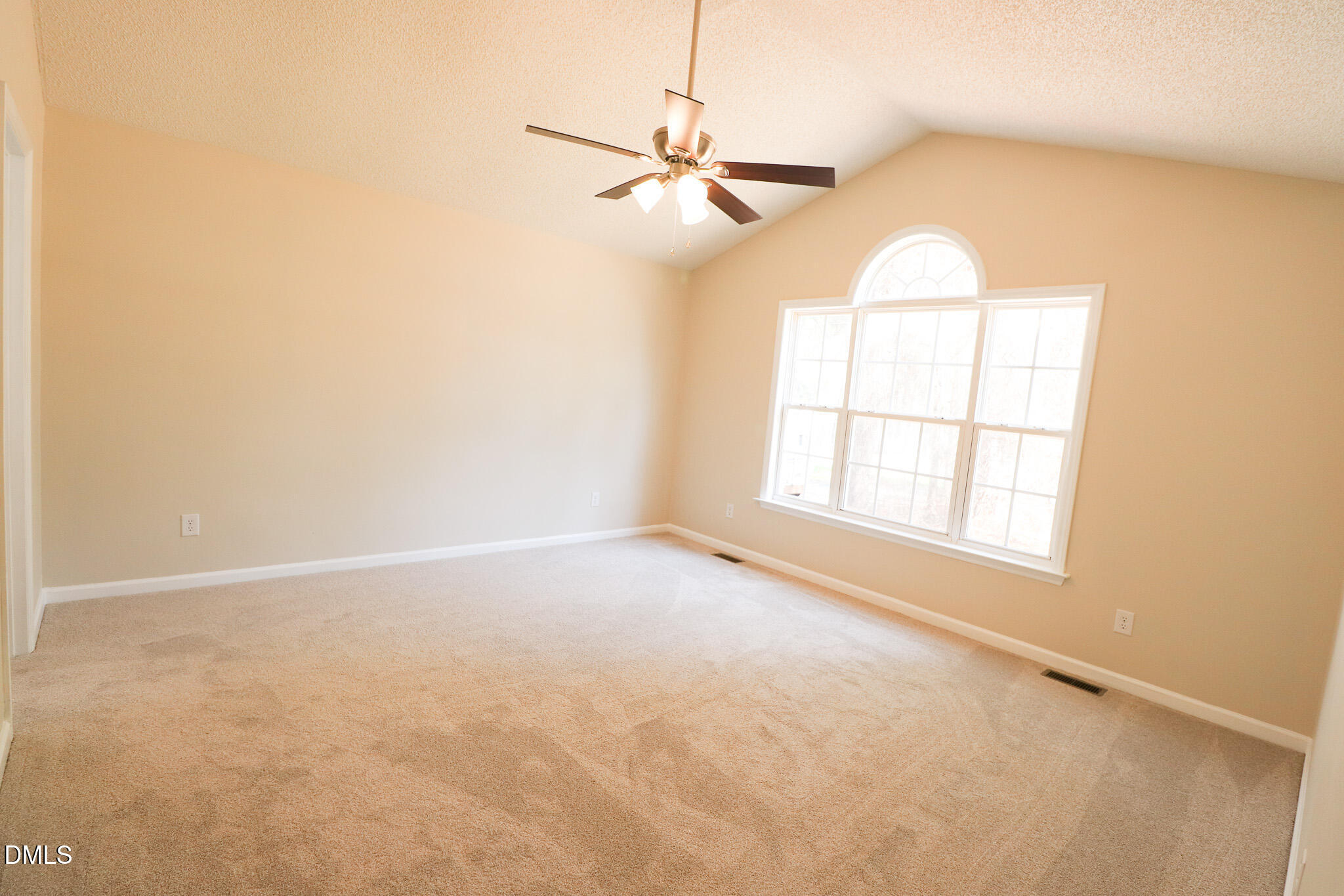 55 Edward Court Willow Spring, NC 27592 - Photo 23 of 25 an empty room with a window and a ceiling fan