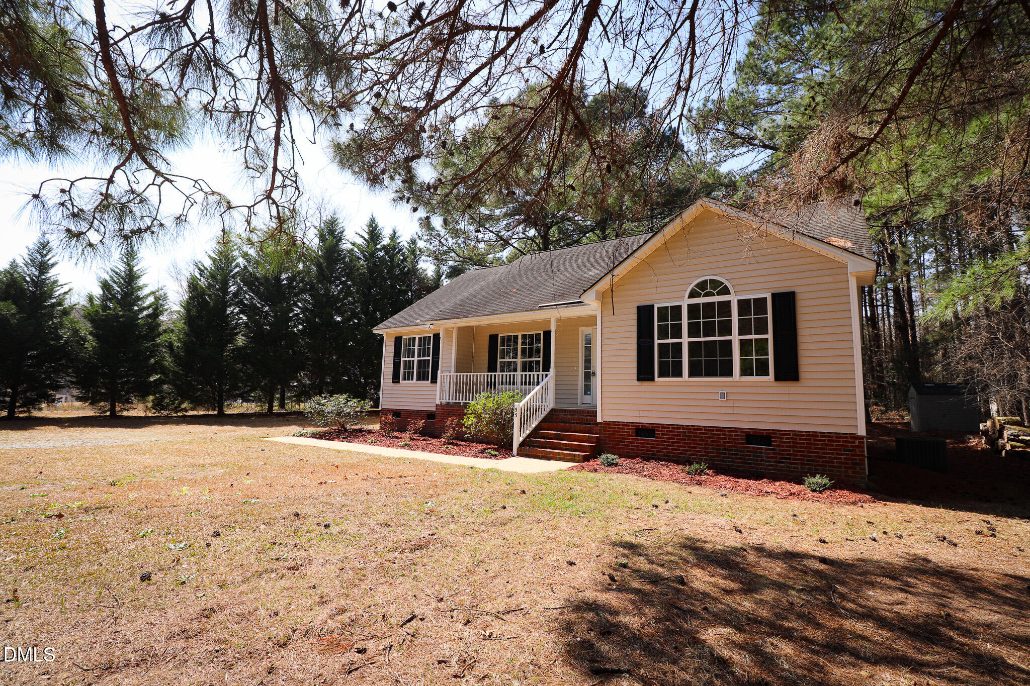 55 Edward Court Willow Spring, NC 27592 - Photo 2 of 25 a front view of a house with a yard covered with snow in front of house