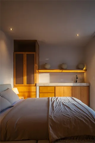 a bedroom with a bed and a night stand