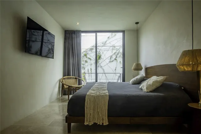 a bedroom with a bed and a window