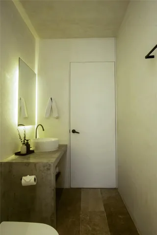 a bedroom with a bed and lamp