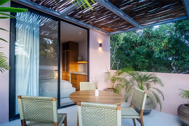 a front view of a house with a yard and potted plants