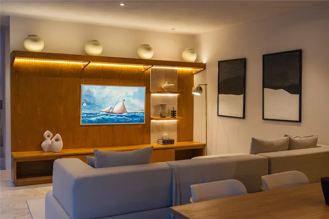 a living room with furniture and a potted plant