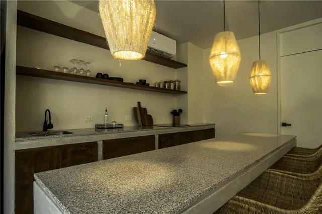 a kitchen with stainless steel appliances granite countertop a sink a stove and a wooden floor